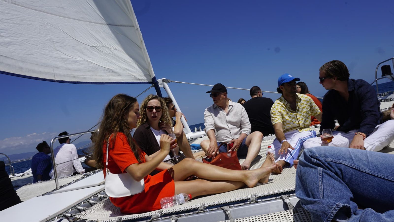 Attendees relaxing on deck during the networking sailboat experience